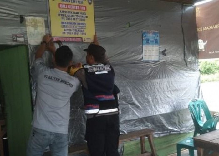 Bhabinkamtibmas Pasang Spanduk Call Center 110 Polres Aceh Tenggara Nomor HP Kapolsek serta Bhabinkamtibmas